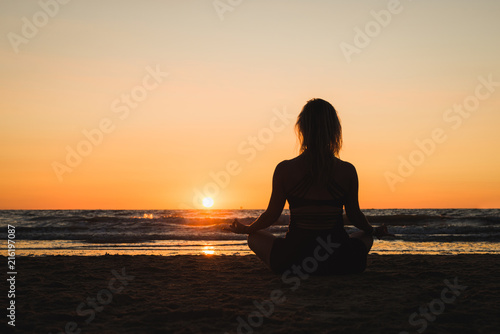 Silhouette of a girl practicing yoga