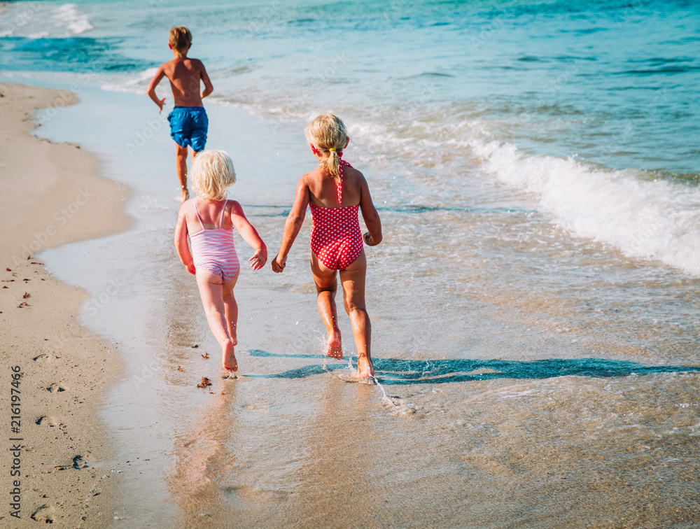 little boy and girls run play at beach little boy and girls run play at beach