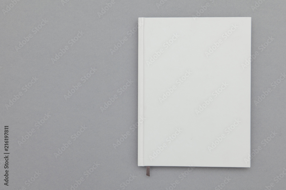 Hardback book cover mockup. White book on a grey background Hardback book cover mockup. White book on a grey background