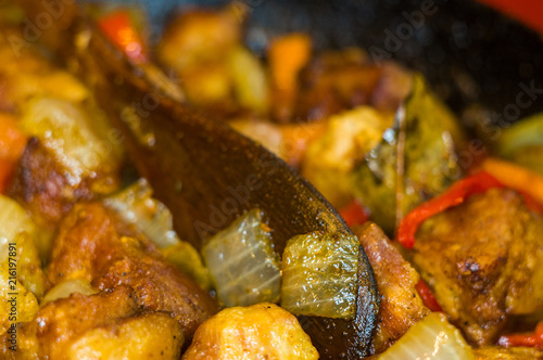 Roast meat, onions, carrots and spices, boiling in oil © Wingedbull