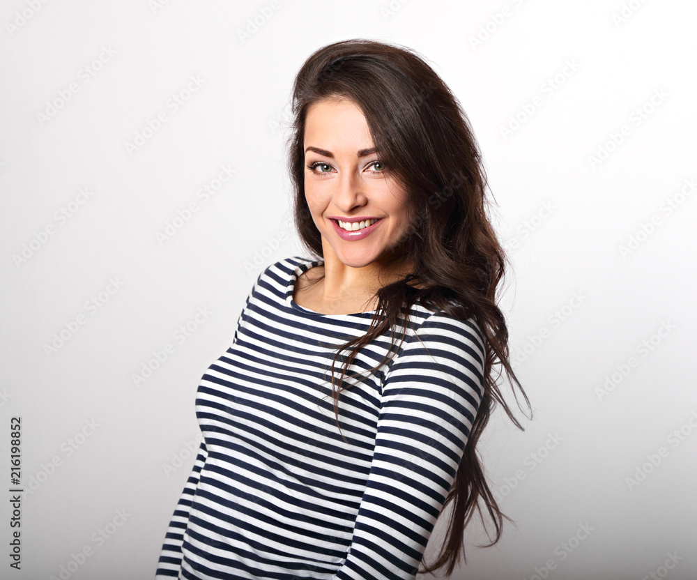 Happy emotional woman thinking and looking with toothy smiling in stripped casual clothing Happy emotional woman thinking and looking with toothy smiling in stripped casual clothing