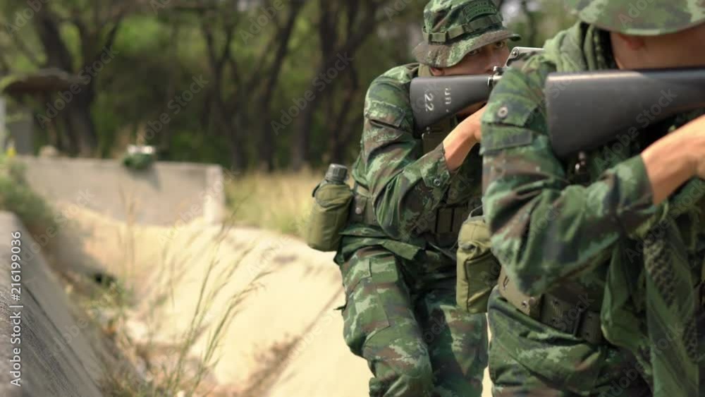 Soldier armed with a reconnaissance patrol in the woods. Concept of war ...