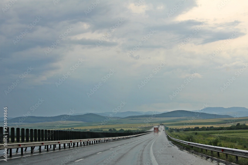 Fototapeta premium Highway under dark sky - after rain