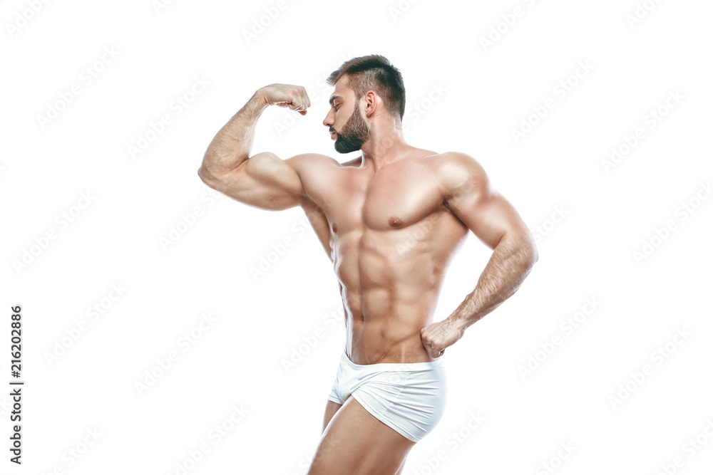 bodybuilder posing. Beautiful sporty guy male power. Fitness muscled manin white lingerie. on isolated white background. bodybuilder posing. Beautiful sporty guy male power. Fitness muscled manin white lingerie. on isolated white background.