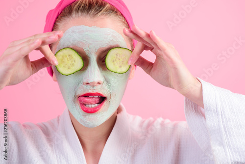 Cosmetic mask.Close-up portrait of beautiful woman with facial mask. Spa salon. Cosmetic mask with cucumber slices. Natural ingredients. Wellness and Spa concept. Natural beauty. Perfect skin.