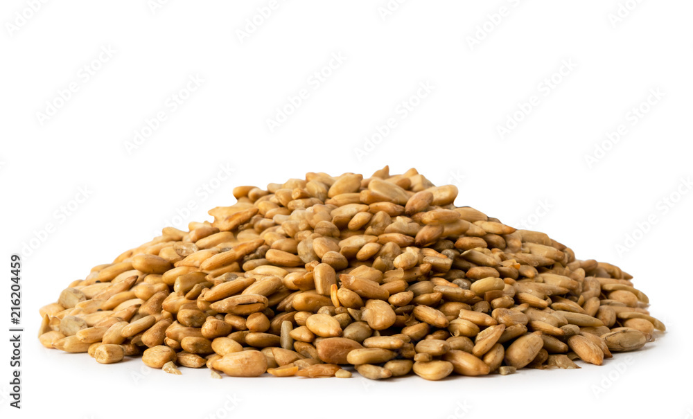 A handful of peeled sunflower seeds on a white background. A handful of peeled sunflower seeds on a white background.