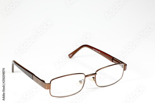 Reading glasses sitting on a white counter waiting to be used