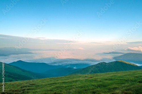 morning in the mountains over white clouds