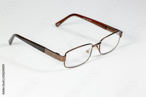 Reading glasses sitting on a white counter waiting to be used