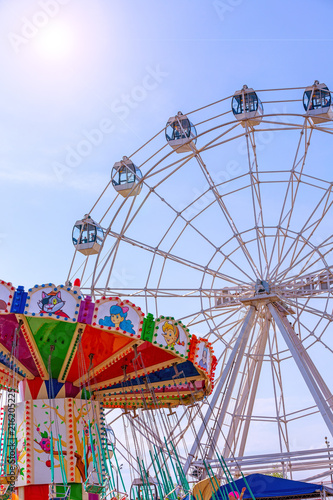 Amusement park rides with a very blue sky as background. © Georgii
