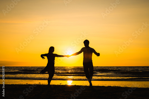 Beautiful silhouettes of dancers at sunset