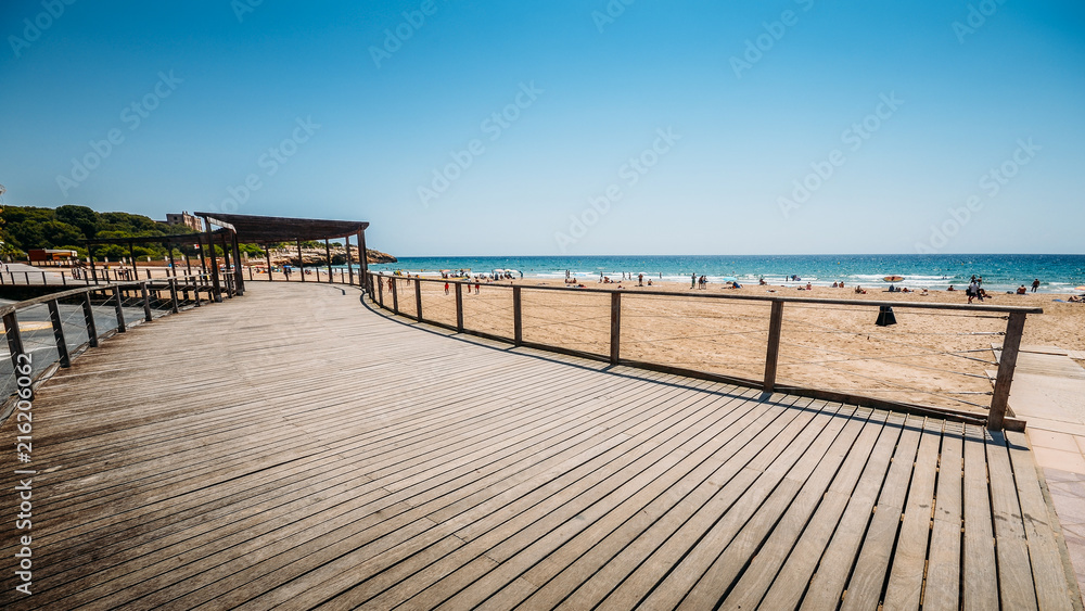 Vacationers in Arrabassada Beach, one of the famous golden sand beaches in the Spanish Costa Daurada Vacationers in Arrabassada Beach, one of the famous golden sand beaches in the Spanish Costa Daurada