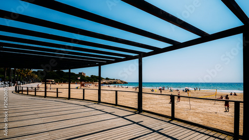 Vacationers in Arrabassada Beach, one of the famous golden sand beaches in the Spanish Costa Daurada photo