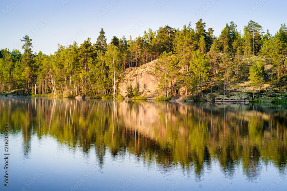 Forest lake at sunrise in Karelia