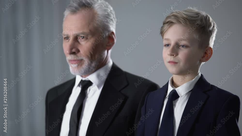Adult and junior gentlemen adjusting ties to give good impression, mans image Adult and junior gentlemen adjusting ties to give good impression, mans image