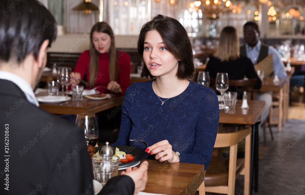 Woman with male colleague in restaurant