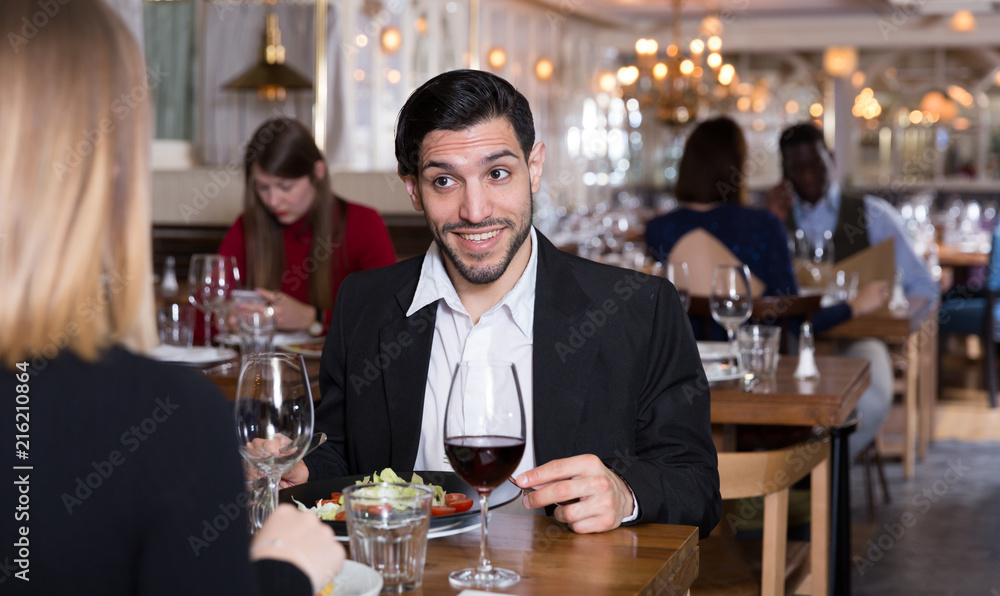 Cheerful man with female in restaurant
