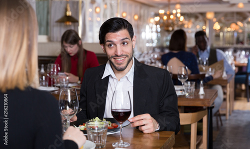 Cheerful man with female in restaurant