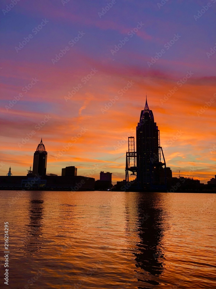 Fototapeta premium Waterside sunset sunrise over the city 
