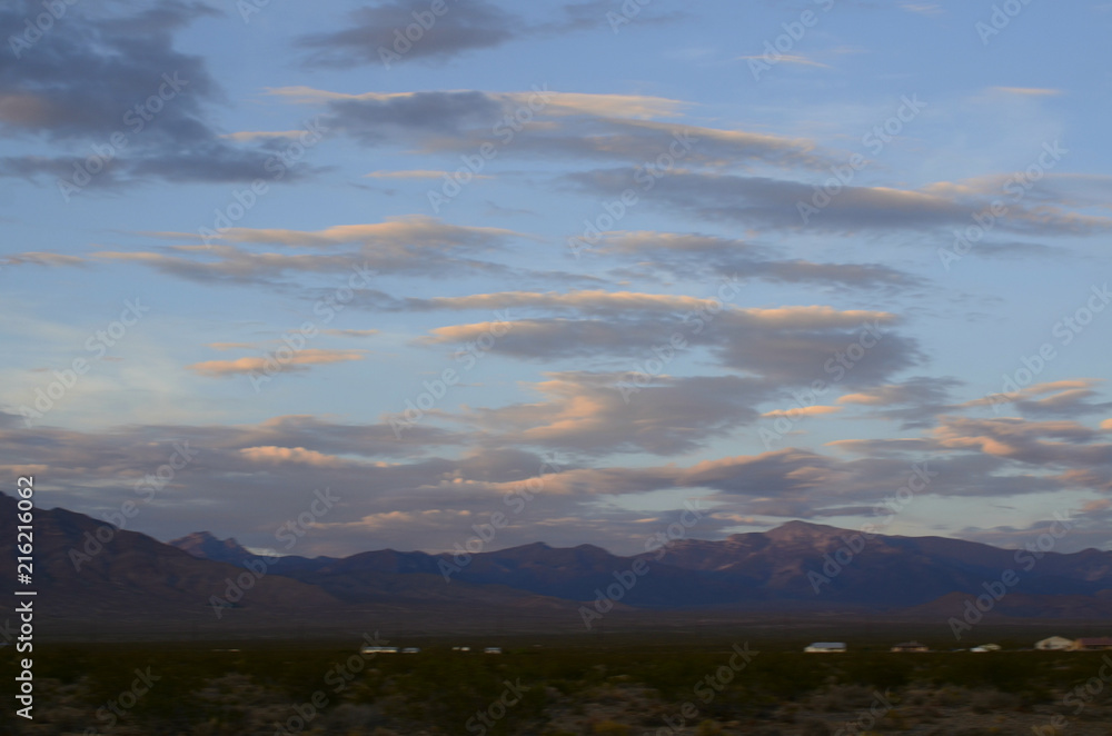 sunrise clouds over mountains in Mojave Desert town Pahrump, Nevada, USA