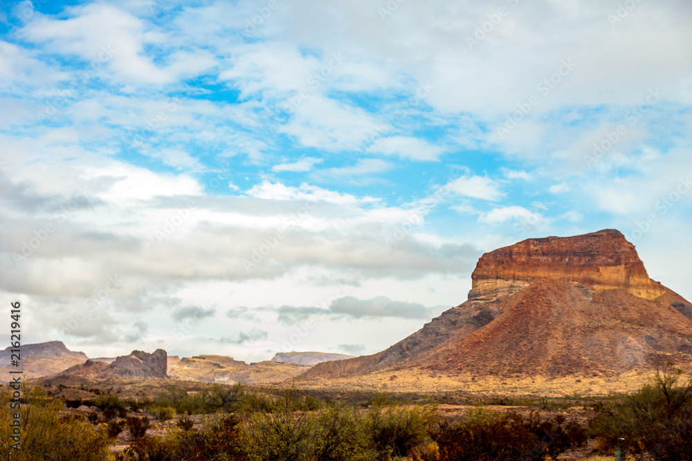 Beautiful landscape of a large mountain and blue sky with white clouds in the desert southwest