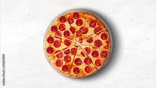 Video pepperoni pizza on a white marble kitchen table. 