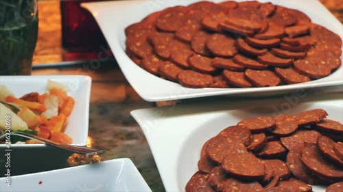 Buffet, salad and salami sausage. photo