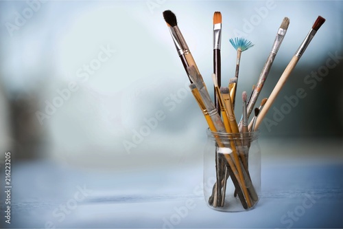 Fototapeta Naklejka Na Ścianę i Meble -  Brushes on wooden table on background