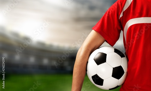 Young Male Soccer Player on blurred stadium