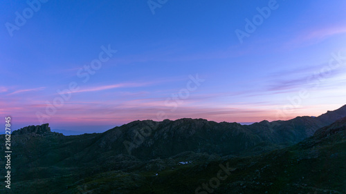 Pink sunset with mountain silhouette in background