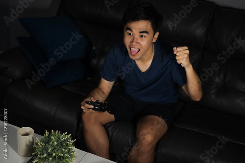 man playing video games and wins at night