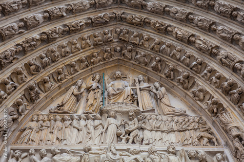 Details of the west facade of the Cathedral of Our Lady of Paris in a freezing winter day just before spring