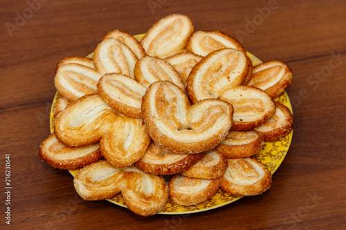 Wallpaper Mural Palmier biscuits - french cookies made of puff pastry (also called palm leaves, elephant ears or french hearts) in a plate on wooden table Torontodigital.ca