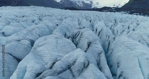 Aerial of expansive glacier in mountainous Icelandic valley