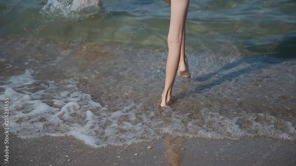 Legs in sea water, with an influx of waves. Legs in sea water, with an influx of waves.