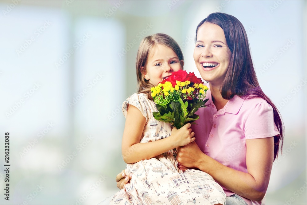 Portrait of happy mother and daughter holding