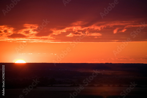 Wallpaper Mural Evening sky and sun shine through the field. Sunset on the field Torontodigital.ca