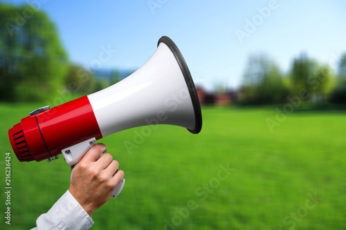 Human Hand with Megaphone on natural background