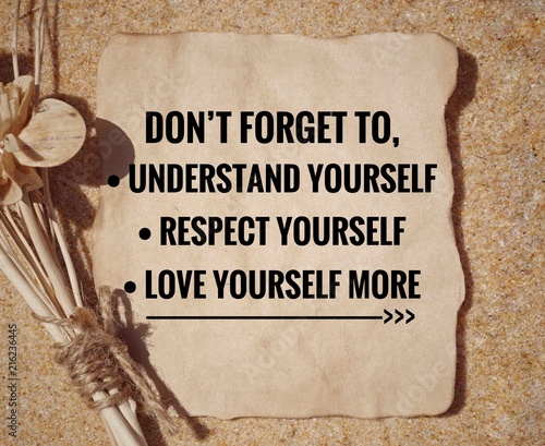 Motivational and inspirational quote - ‘Don’t forget to understand yourself, respect yourself, love yourself more’ written on a paper. Vintage styled background. photo