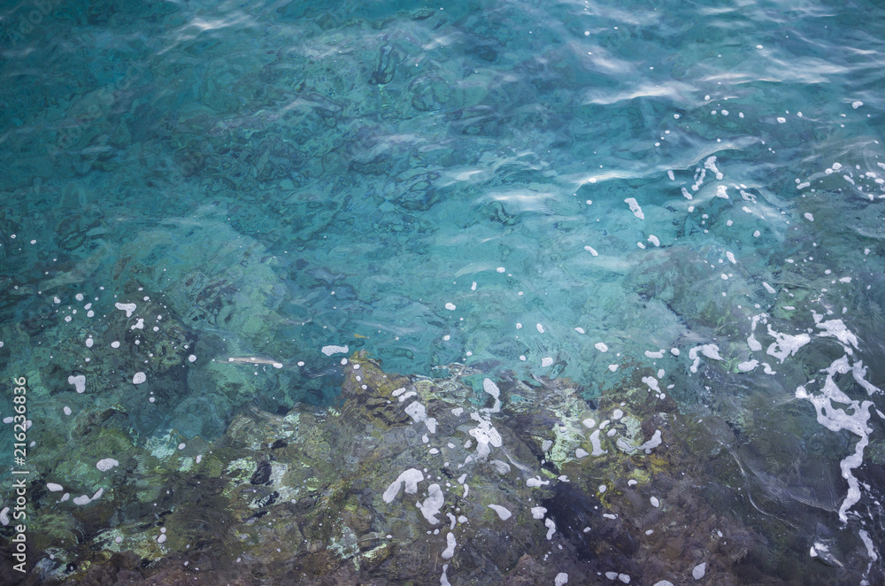 Clear blue sea water and rocks