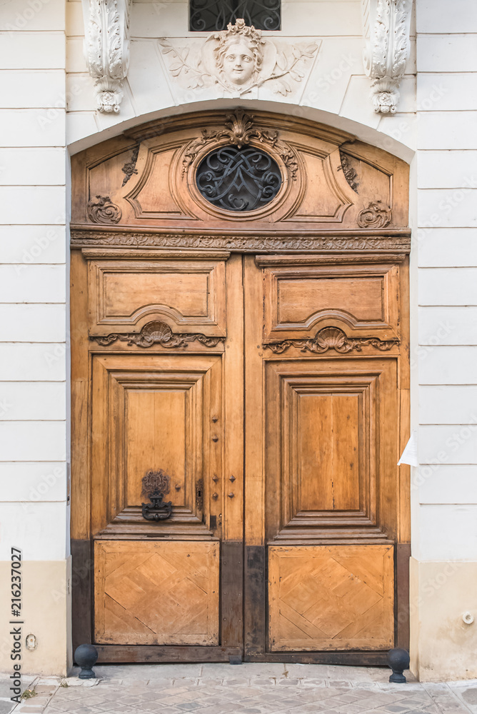 Fototapeta premium Paris, old wooden door on the ile de la Cite, beautiful entry porch 