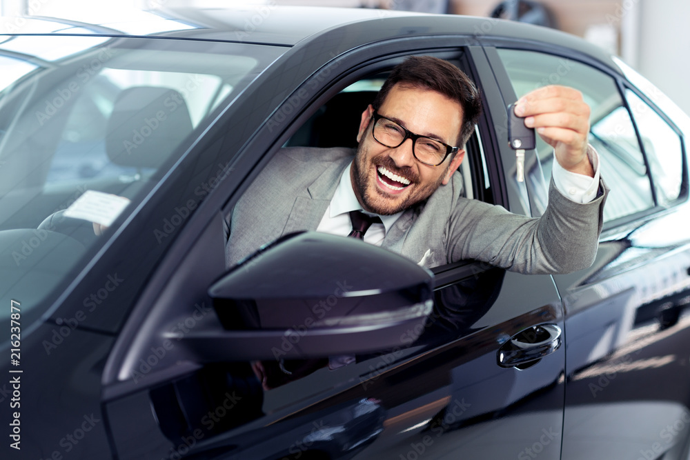 Salesperson selling cars at car dealership