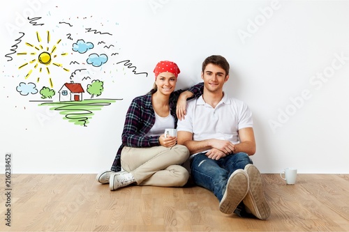 Portrait Of Happy Young Couple Sitting