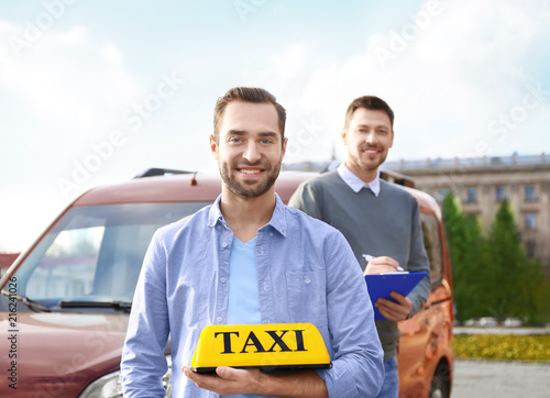 Happy young man holding tax...