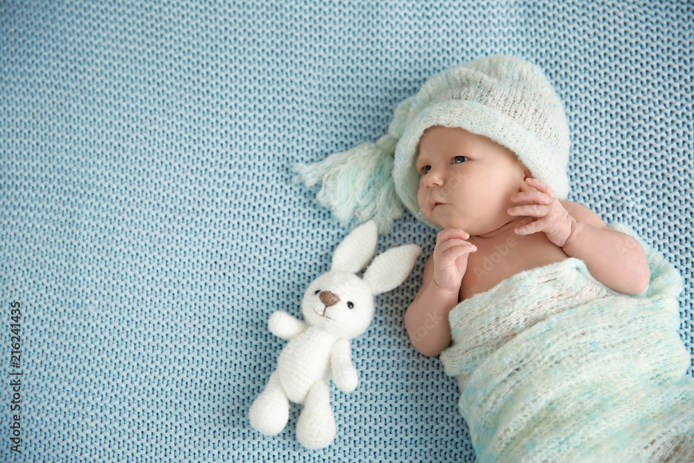 Fototapeta premium Cute newborn baby girl lying on plaid
