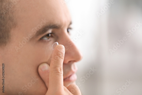 Young putting contact lens ...
