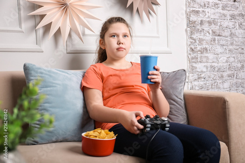 Overweight girl playing vid...