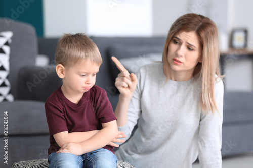 Canvas Print Mother scolding her little son at home