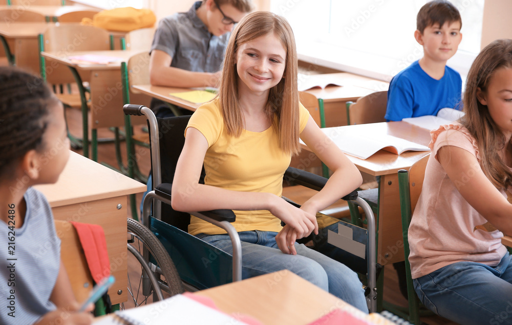 Φωτογραφία Teenage girl in wheelchair with classmates at school