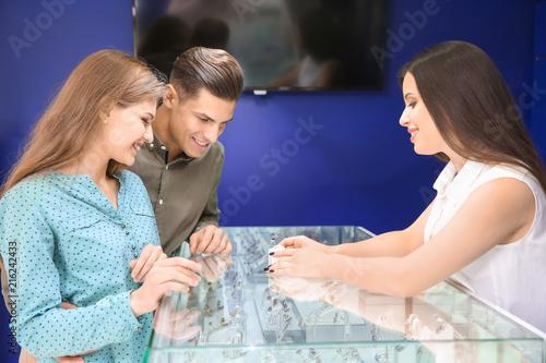 Young couple choosing ring ...